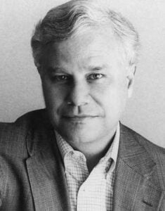 Whitley Strieber in a suit, black and white photo.