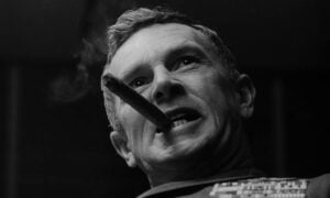 Sterling Hayden smoking a cigar in a black and white photo from the movie "Dr. Strangelove."